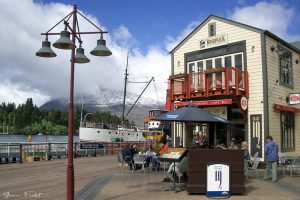 Queenstown pedestrian precinct with steamer Earnslaw in the background New Zealand